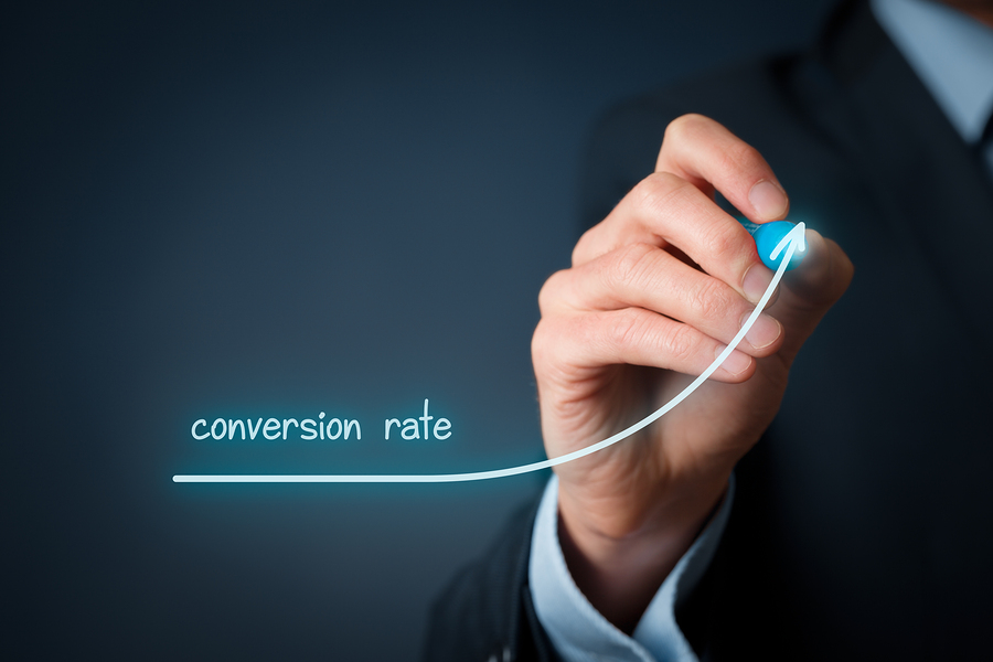 Business person drawing an upward arrow to show increasing conversion rate performance